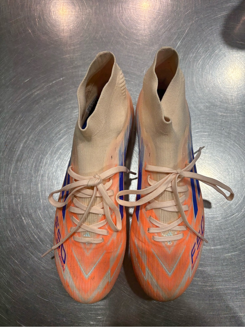 Light Peach Knit Soccer Cleats with Orange and Blue Accents
